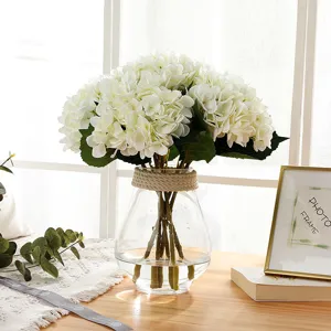 Artificial white hydrangea bouquet in glass vase with rope detail, perfect for home decor.