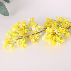 Artificial yellow osmanthus flower branch detail close up, realistic faux floral decor.