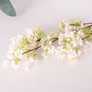 Artificial pink flower branch detail close up, home decor floral arrangement prop.