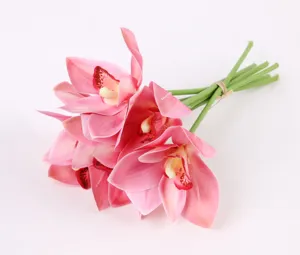 Detailed closeup of artificial pink cymbidium orchid bundle, elegant floral decor for living room.