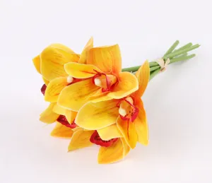 Closeup of artificial yellow cymbidium orchid bouquet, detailed texture and vivid color for home
