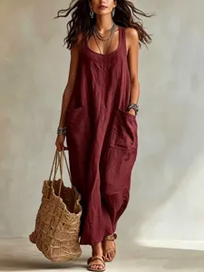 Close-up view of casual sleeveless linen jumpsuit with large side pockets and layered necklaces.