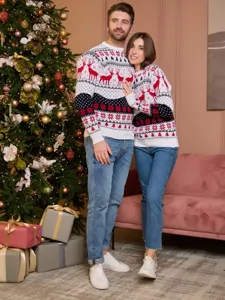 Detailed view of Christmas couple sweaters with festive reindeer and snowflake jacquard patterns.