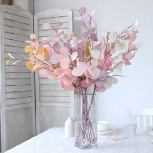 Artificial eucalyptus leaves branches in clear glass vase for home decor wedding table setup