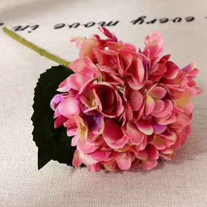 Artificial hydrangea detail, pink flower head with green stem for home wedding decor.