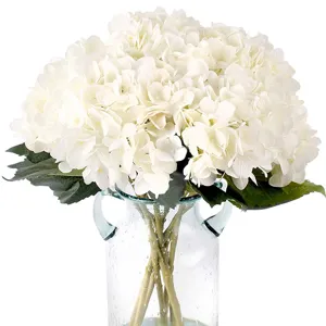 White artificial hydrangea flowers bouquet in clear glass vase for home wedding decor