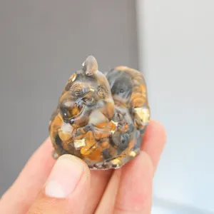 Detailed close-up view of a cute resin cartoon hen figurine, small decorative ornament.