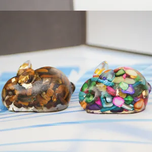 Detailed close-up of resin crystal stone bunny figurine with colorful crushed stones inside.