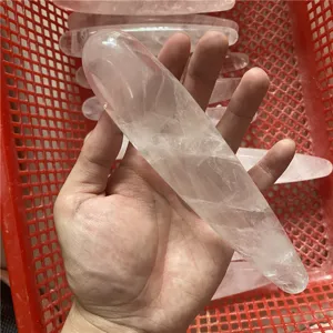 Natural crystal massage wand detail view, smooth polished surface, adult wellness product.