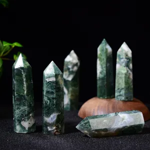 Natural moss agate crystal tower detail showing unique green patterns and polished hexagonal point.