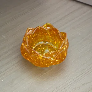 Close-up of golden resin lotus cornucopia ornament with sparkling crystal chips inside.