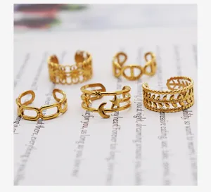 Detailed shot of stackable gold titanium steel rings with bohemian geometric cutouts.