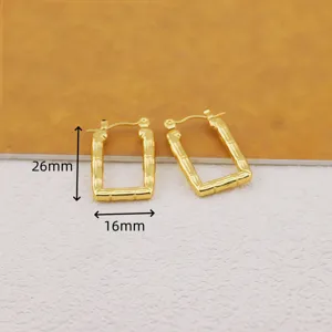 Close-up detail shot of rectangular bamboo pattern gold plated hoop earrings with clear size marks.