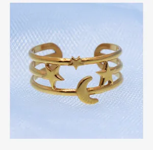 Close-up of the gold-tone multi-layer open ring showcasing delicate star and moon motifs.