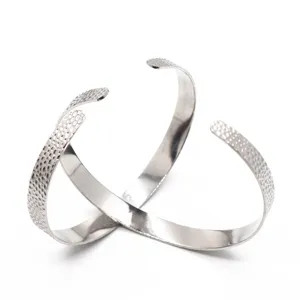 Stainless steel hammered open cuff bracelet detail view showing unique textured surface.
