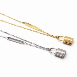 Close-up detail of dual-tone padlock clavicle chain, featuring metal lock and side bar charm.