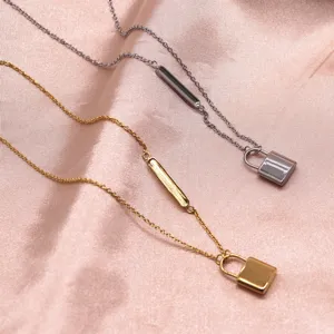 Detail shot of stylish gold and silver padlock clavicle necklaces with side bar design charms.