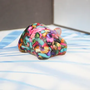 Detailed close-up of colorful crystal crushed stone cute pig resin craft home ornament.