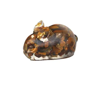 Resin crouching rabbit ornament filled with natural crystal stone chips and shiny gold foil.