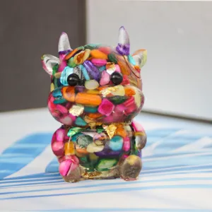 Crystal stone epoxy resin cartoon bull ornament detail view, colorful craft desktop decor.