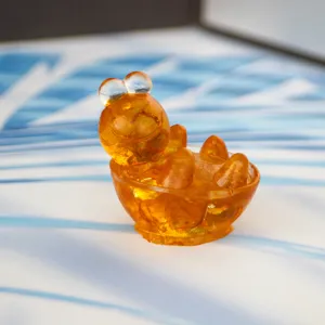 Resin amber turtle figurine detail view, cute transparent orange desk ornament for office decor.