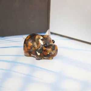 Detail view of cute pig resin ornament filled with natural crystal chips for home car decor.