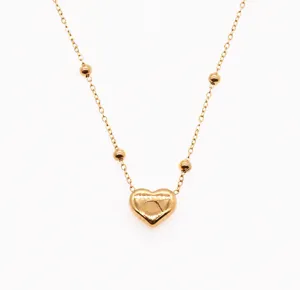 Stainless steel heart pendant necklace detail, featuring 3mm beads and adjustable chain.