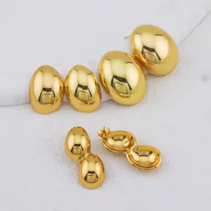 Detailed view of gold-plated stainless steel earrings featuring smooth round and double-ball drop.