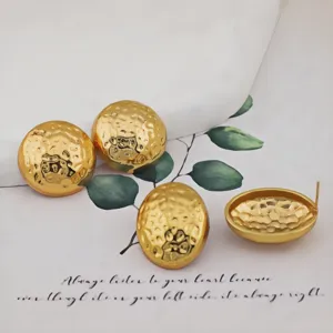 Gold textured dome earrings detail, polished stainless steel chic minimalist design.