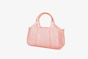 Detail view of transparent pink PVC jelly handbag featuring stylish mesh lattice design and tote.