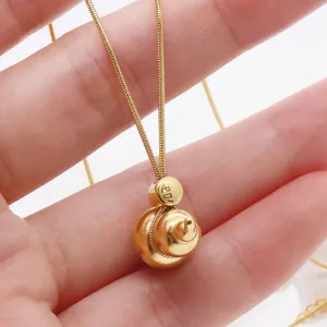 Close-up detail of a modern Chinese style gold gourd pendant necklace with delicate chain.
