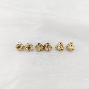 Gold plated lotus and flower spacer beads detail view, perfect for DIY jewelry making accessories.