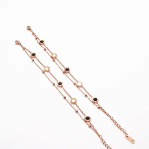 Rose gold double-layer stainless steel bracelet with black and white circular charms for women.