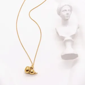Detailed view of the gold stainless steel gourd pendant necklace, delicate chain close up.