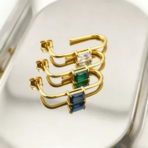 Detailed close-up of gold-plated stainless steel U-shaped earrings with colorful emerald-cut stones.