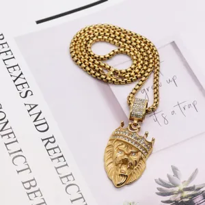 Detailed close-up of gold stainless steel hip-hop lion head pendant necklace with rhinestones.