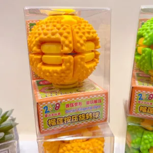 Close-up detail of the yellow durian fingertip gyro decompression toy inside its clear box.