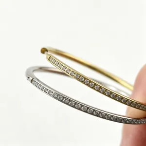 Stainless steel paved hoop earrings, elegant gold and silver clasp design for versatile daily wear.