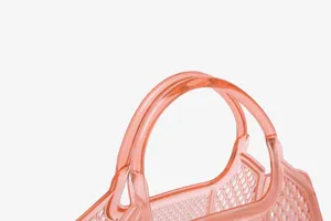 Detail shot of pink translucent PVC jelly bag featuring stylish mesh woven design handle.