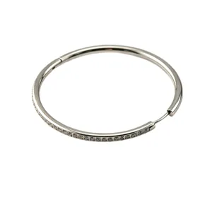 Stainless steel hoop earrings with sparkling diamonds, elegant huggie circle design.