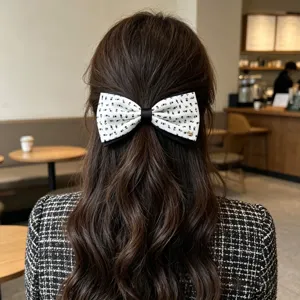 Detailed close-up of the retro floral bow hair clip featuring a charming puppy metal accent.