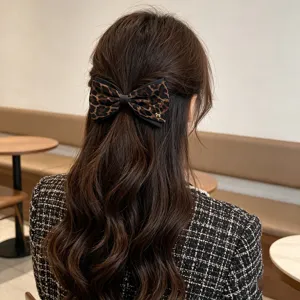 Leopard print bow hair clip for women, chic Korean style retro ponytail spring hair accessory.