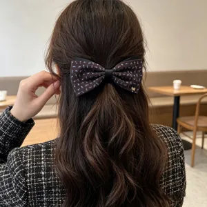 Detailed view of retro floral bow ponytail hair clip featuring cute puppy charm for women autumn.