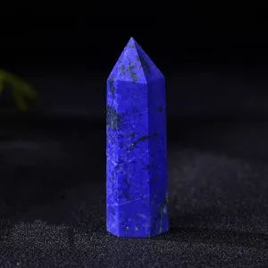 Detail shot of a natural lapis lazuli crystal tower, showing its deep blue hexagonal prism.