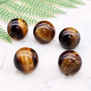 Natural tiger eye crystal spheres polished gemstone ornament detail view display.