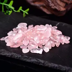 Natural rose quartz crystal chips closeup, small tumbled stones for DIY crystal healing decor.