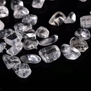 Clear quartz crystal chips detail view, natural raw healing gemstone pebbles for decor and DIY crafts.