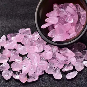 Close-up detail of natural pink crystal gravel, raw rose quartz stones for DIY crafts.