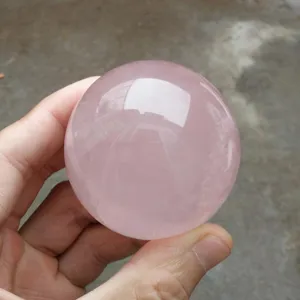 Natural rose quartz crystal ball detail shot, polished healing stone sphere for home decor.