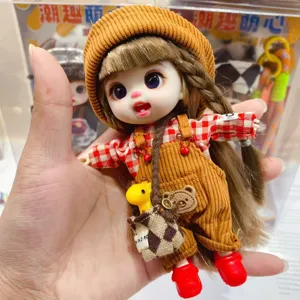 Cute trendy vinyl doll pendant detail, brown overalls and hat, mini giraffe bag, movable joints.